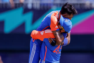 India's captain Rohit Sharma lifts Hardik Pandya as he celebrates the wicket of Pakistan's Shadab Khan during the ICC Men's T20 World Cup cricket match between India and Pakistan at Nassau County International Cricket Stadium in New York on Sunday, June 9, 2024.