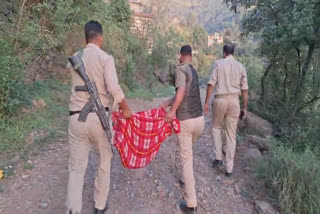 Police officials carrying the bodies of the two newborns on Wednesday.