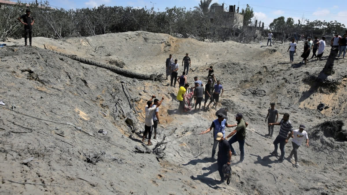 Palestinians search for bodies and survivors in a site hit by an Israeli bombardment on Khan Younis, southern Gaza Strip, Saturday, July 13, 2024.