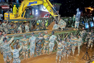 Army personnel work on a footbridge in the landslide-hit Wayanad district of Kerala.