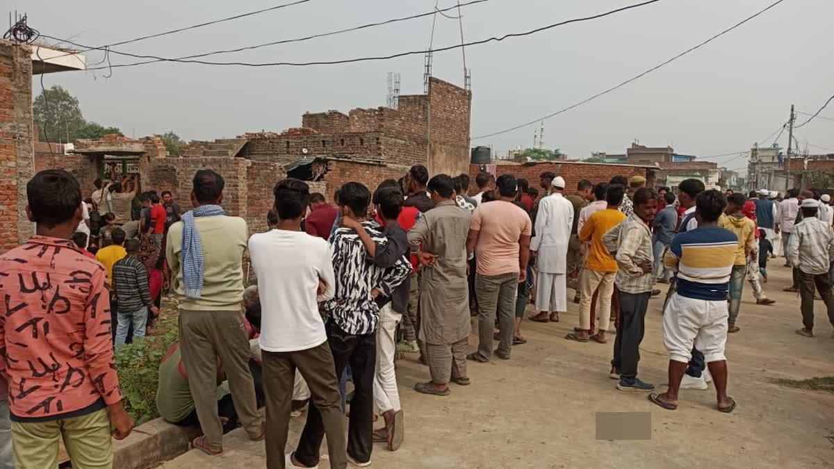 Locals gather outside the house of a couple, who along with their son were stabed to death in Bijnor, Uttar Pradesh. a scrap dealer, his wife and their teenage son were stabbed to death with knives by unidentified assailants while they were sleeping inside their house in Uttar Pradesh's Bijnor