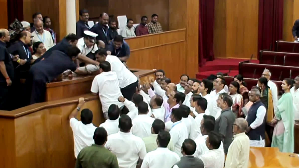 iju Janata Dal (BJD) and Congress MLAs create a ruckus in the Well of the House over the Ganjam liquor tragedy during the Budget Session of the Odisha Assembly, in Bhubaneswar on Friday.