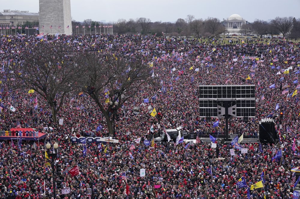 With the Washington Monument in the background, people attend a rally in support of President Donald Trump near the White House on Wednesday, Jan. 6, 2021, in Washington.