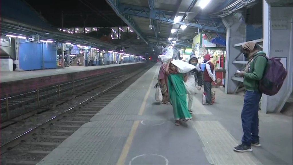 Passengers arrive at Dadar railway station as the local train service resumes for all in Mumbai