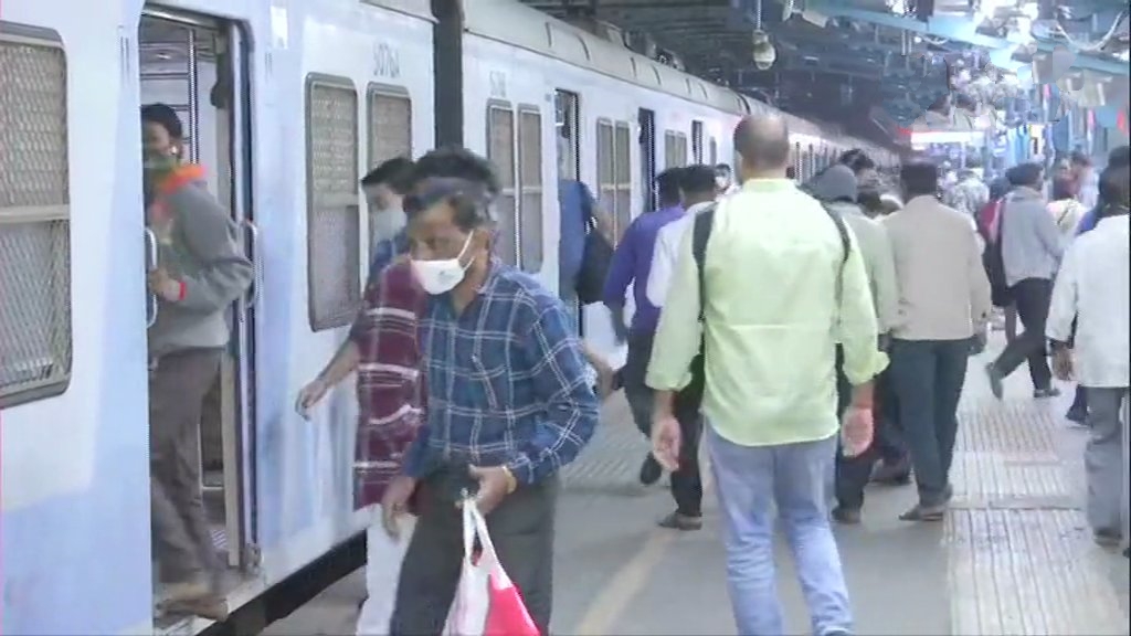 Passengers arrive at Dadar railway station as the local train service resumes for all in Mumbai