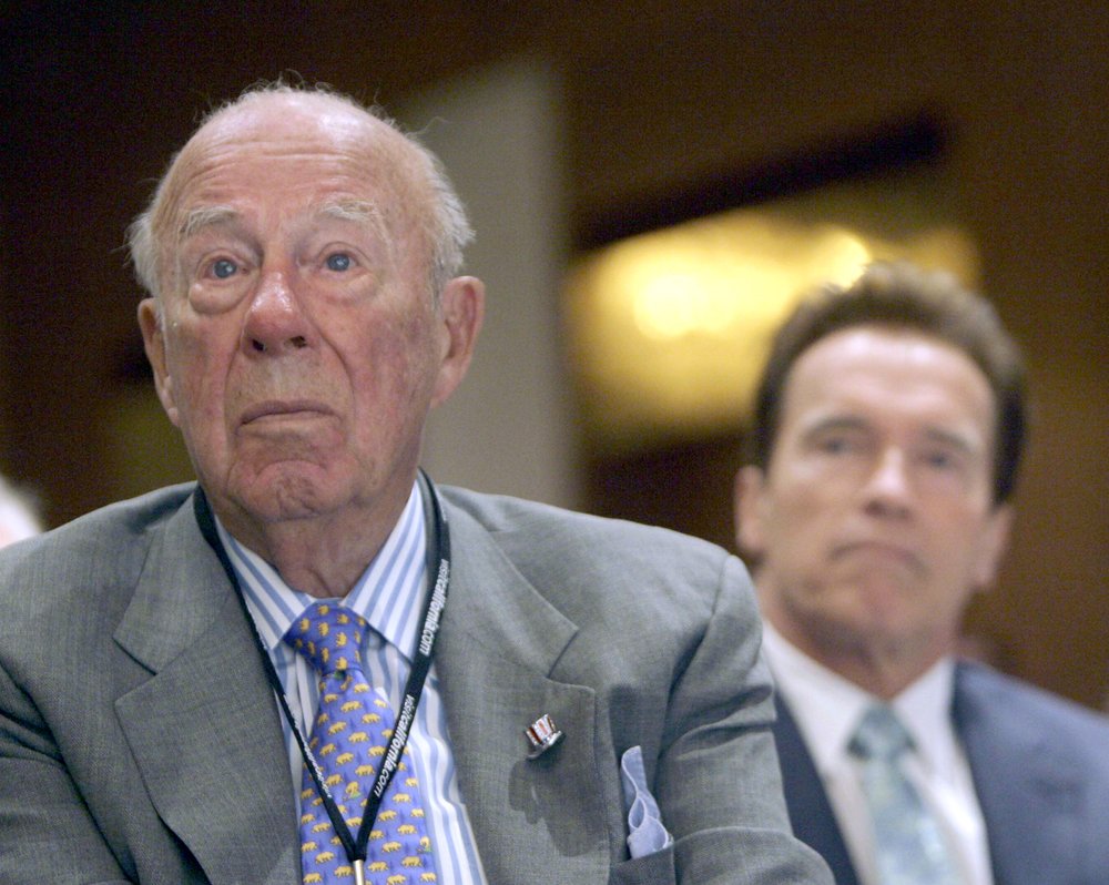 In this Aug. 14, 2008 file photo, former Secretary of State, George Shultz, left, and California Gov. Arnold Schwarzenegger, listen during the opening of the 26th Border Governors Conference, in Los Angeles.