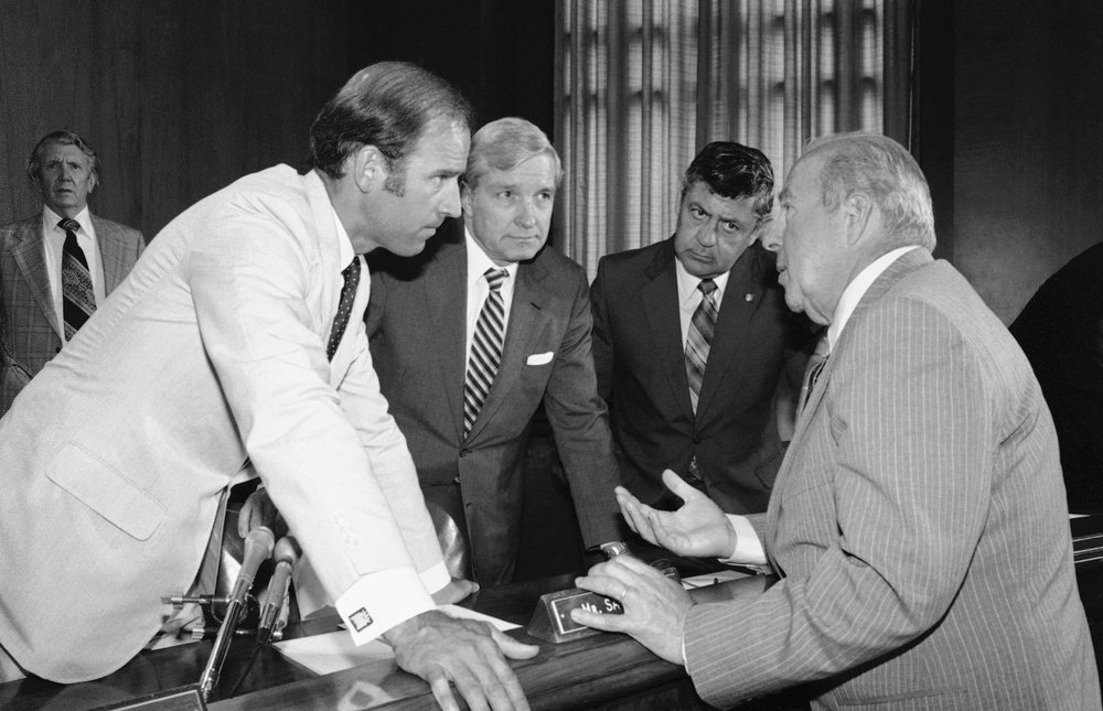 In this July 13, 1982, file photo Secretary of State designate George Shultz, right, speaks with members of the Senate Foreign Relations Committee prior to the start of the afternoon session of the panel on Capitol Hill in Washington. From left are, Sen. Joseph Biden, D-Del.; Sen. Charles Percy, R-Ill., chairman of the panel and Sen. Edward Zorinsky, D-Neb. Shultz, former President Ronald Reagan’s longtime secretary of state,