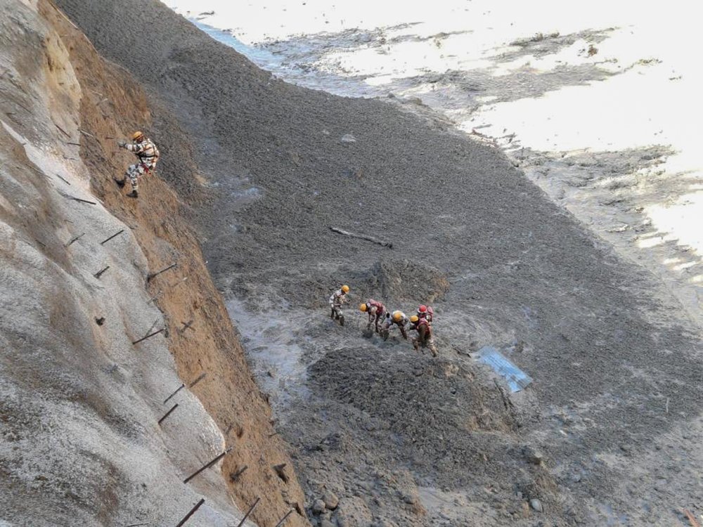 This photograph provided by Indo Tibetan Border Police (ITBP) shows ITBP personnel begin rescue work after a portion of Nanda Devi glacier broke off in Tapovan area