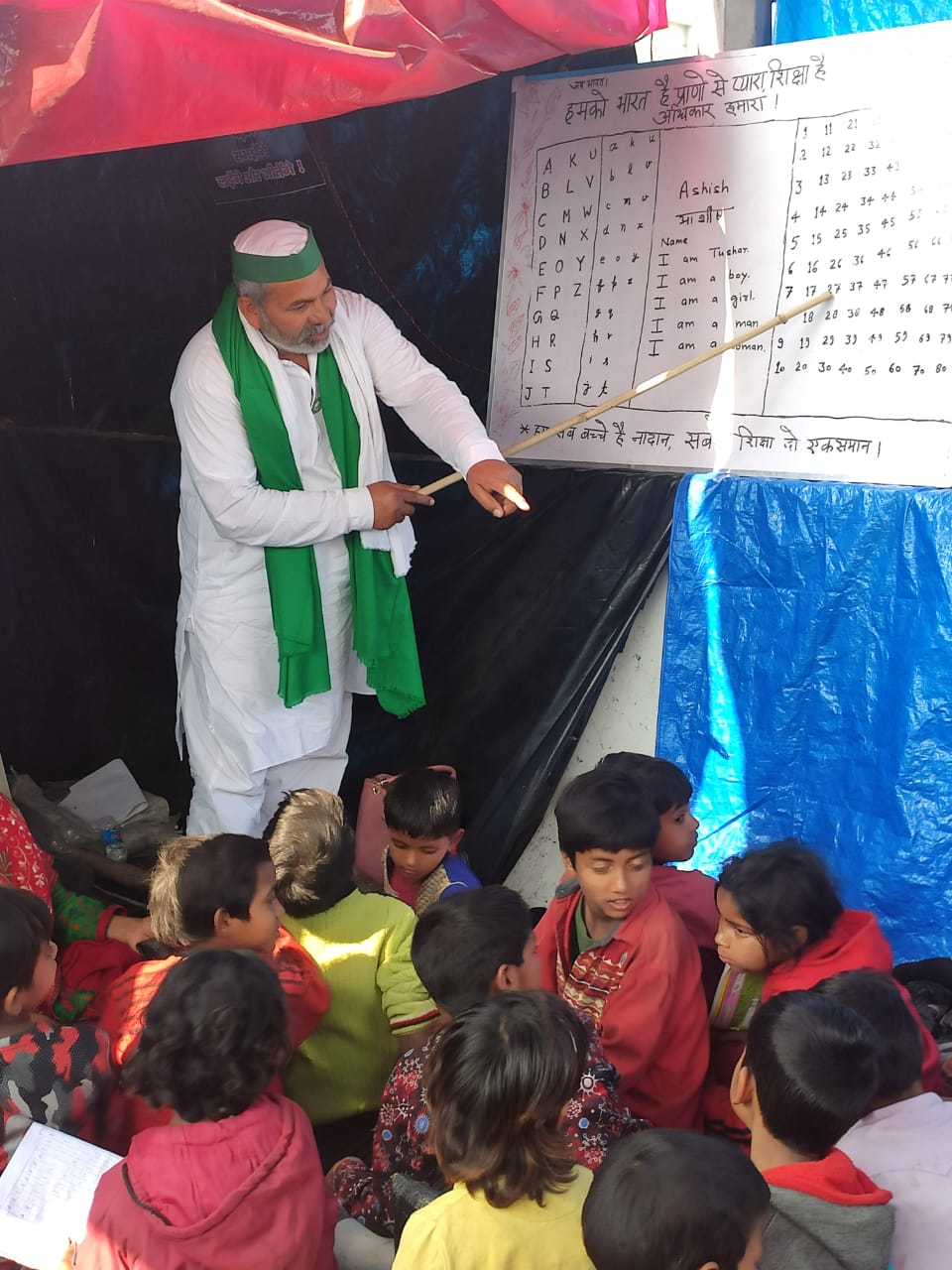 Tikait taught the children at Savitribai Phule school in Ghazipur border