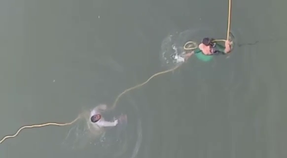 Rescue crew guarding a woman with a rope