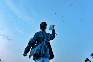 Guy flying kite on a terrace