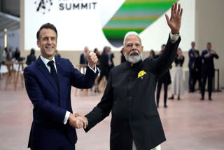 French President Emmanuel Macron, left, poses with India's Prime Minister Narendra Modi at the Grand Palais during the Artificial Intelligence Action Summit in Paris, Tuesday, Feb. 11, 2025.