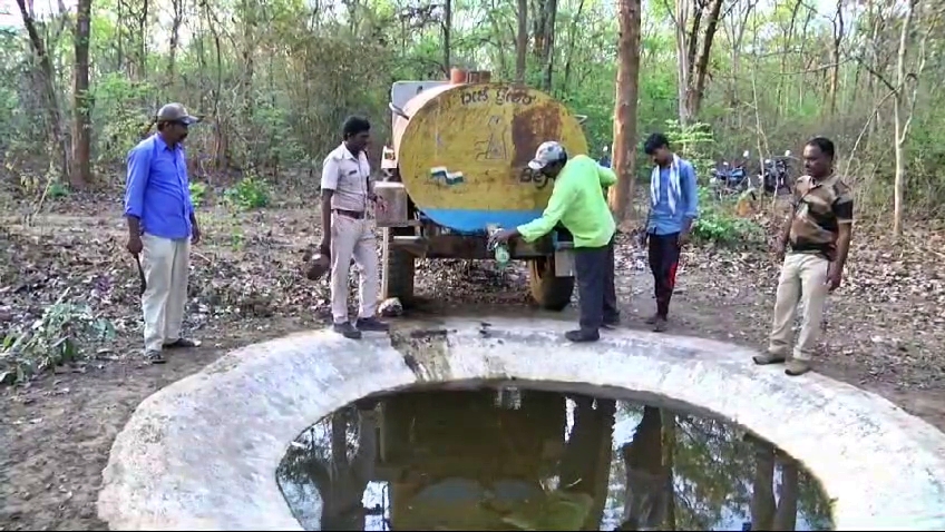 Filling a tank with water from a tanker in the forest