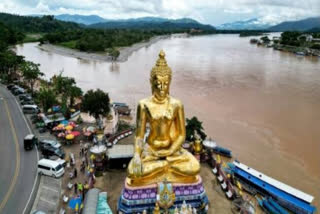 This aerial photo taken on May 25, 2025 shows a giant Buddha statue at a Golden Triangle viewpoint in northern Thailand's Chiang Rai province, with Thailand on left, Myanmar in centre, Laos on right.