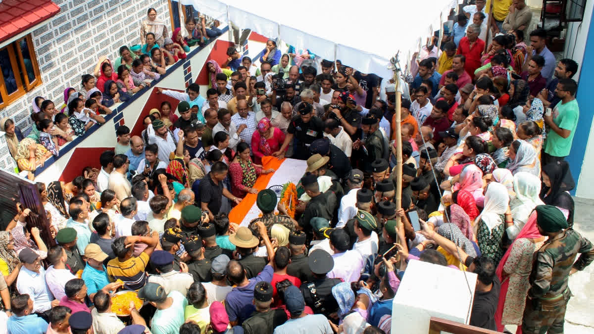 National Flag being laid over mortal remains of Naik Vinod Singh at Bhaniyawala village in Dehradun on Wednesday. Singh was one of the five army soldiers killed in July 8 Kathua terrorist attack.