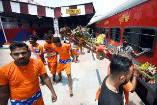 Kanwariyas board a train at railway station during their Kanwar Yatra in the month of Sawan