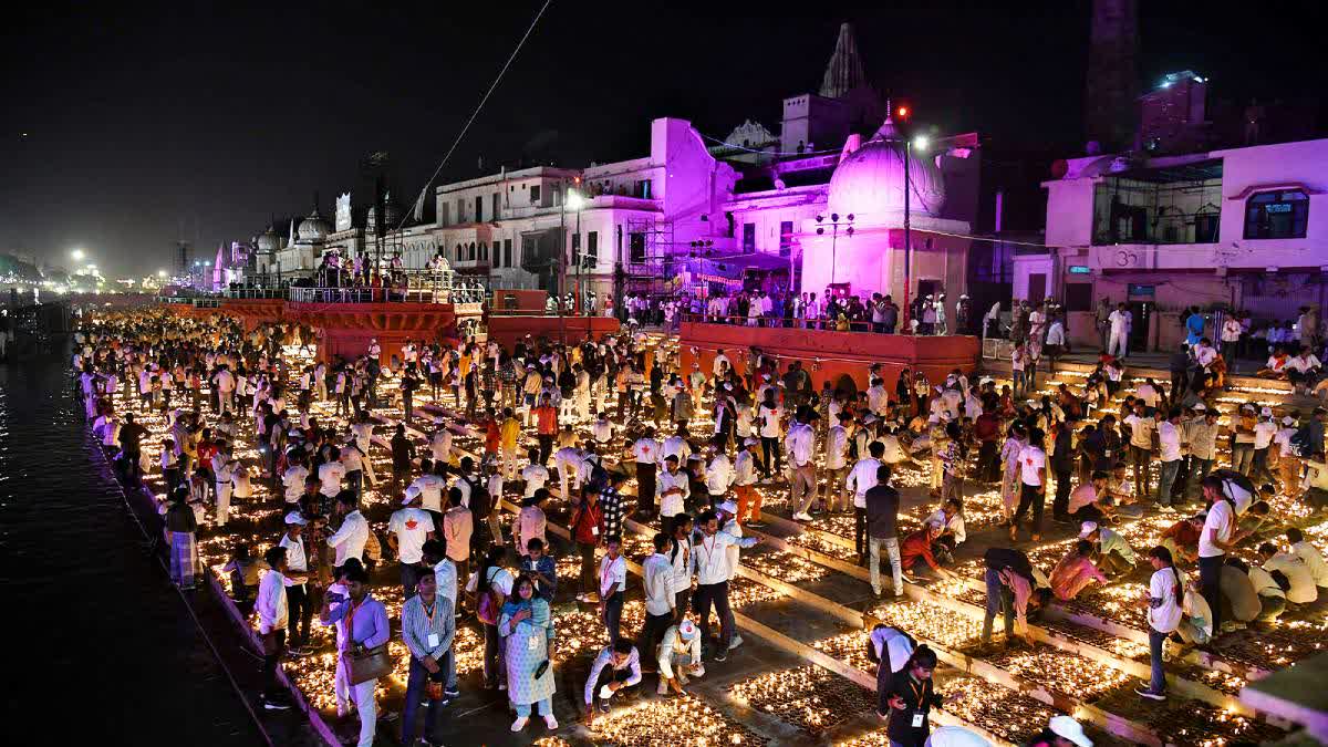 Devotees light earthen lamps on the banks of Saryu river during the Deepotsav celebrations