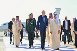 Saudi Deputy Governor of the Riyadh region Prince Mohammed bin Abdulrahman bin Abdulaziz (R) welcoming Lebanon's caretaker Prime Minister Najib Mikati (C) upon his arrival in Riyadh, a day ahead of the Organization of Islamic Cooperation and the Arab League joint extraordinary leaders summit.