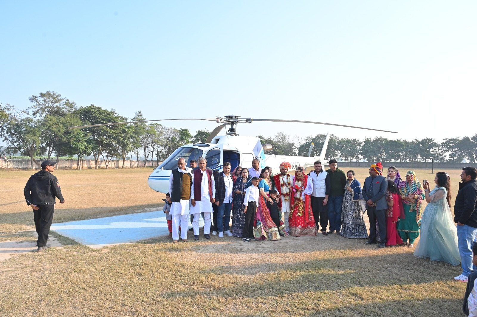 bride and groom's family present at the helipad