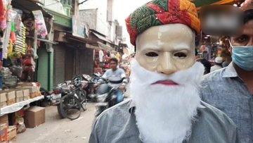 Ahead of Holi festival, shopkeepers in Aligarh say there is an increase in demand of PM Modi's plastic face mask & his beard