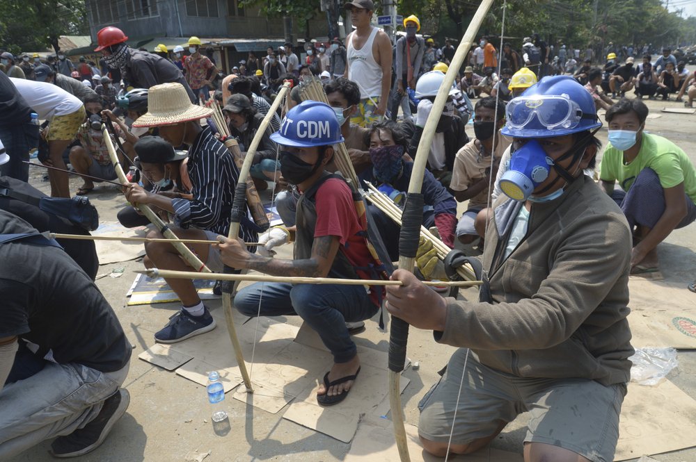 Anti-coup protesters prepare makeshift bow and arrows to confront police in Thaketa township Yangon