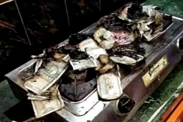 Man burns money on gas stove as ACB raids his house