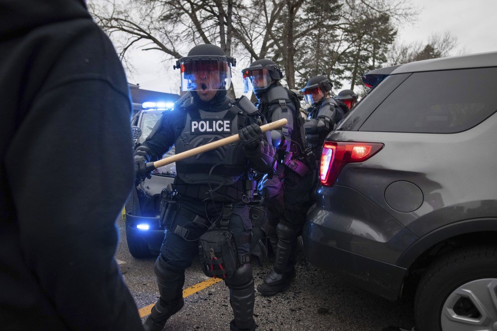 Police respond to the scene near the site where a family said a man was shot and killed by local law enforcement,