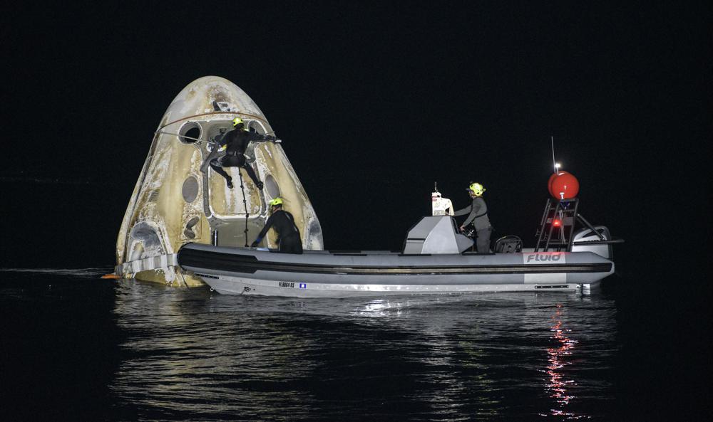 Within a half-hour of splashdown, the charred capsule — resembling a giant toasted marshmallow — had been hoisted onto the recovery ship, with the astronauts exiting soon afterwards