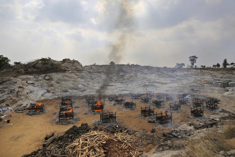 Funeral pyres of twenty-five COVID-19 victims burn at an open crematorium