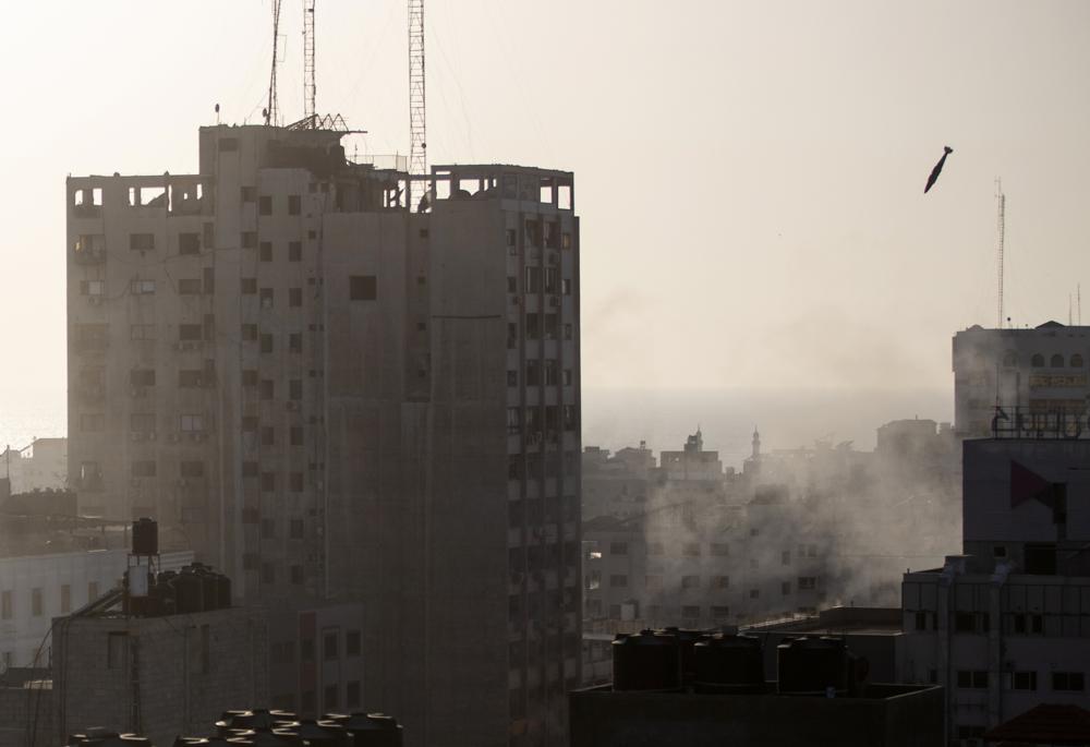 An Israeli missile flies down to hit a building in Gaza City