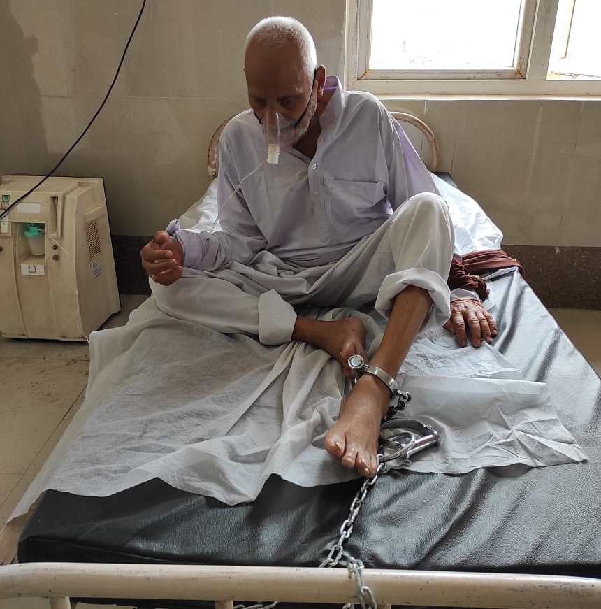 old man tied with chains in covid ward