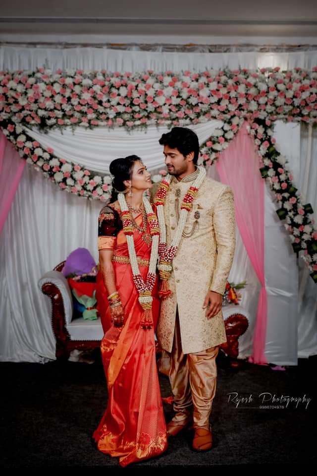 A married couple wearing a mask