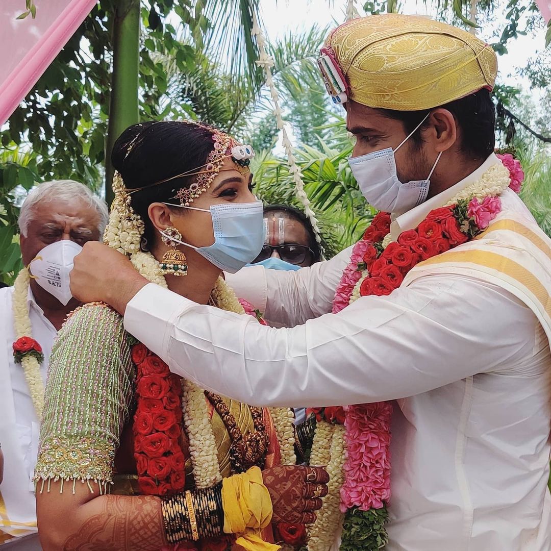 A married couple wearing a mask