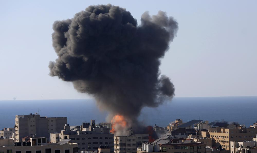 Smoke rises following Israeli airstrikes on a building in Gaza City