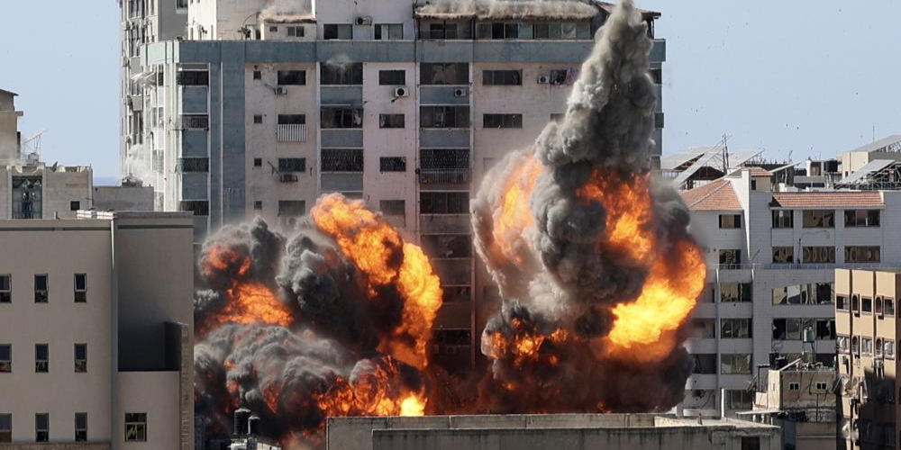 The building housing the offices of The Associated Press and other media in Gaza City collapses after it was hit by an Israeli airstrike