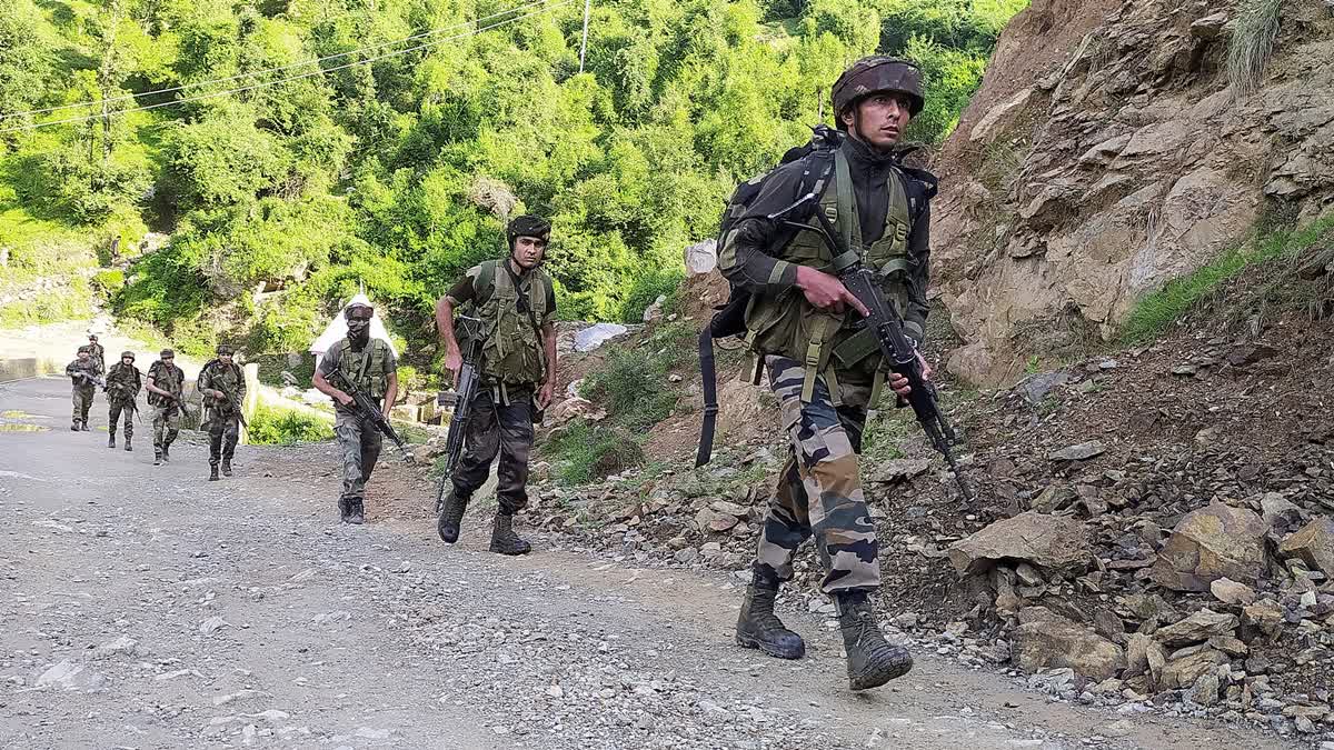 Security personnel conduct a search operation, where an army convoy was attacked by terrorists in the Machedi area, in Kathua on Tuesday.