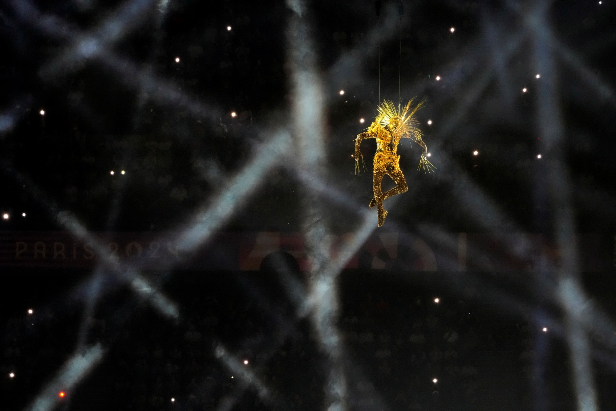 A performer descends during the 2024 Summer Olympics closing ceremony at the Stade de France, Sunday, Aug. 11, 2024, in Saint-Denis, France.