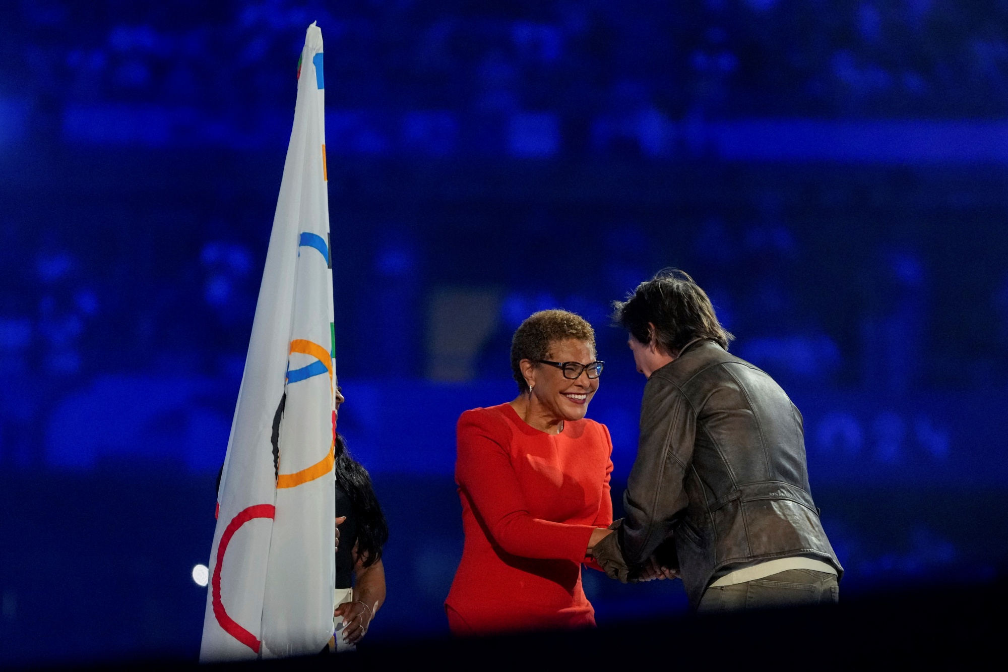 Tom Cruise greets Los Angeles Mayor Karen Bass during the 2024 Summer Olympics closing ceremony at the Stade de France, Sunday, Aug. 11, 2024, in Saint-Denis, France.