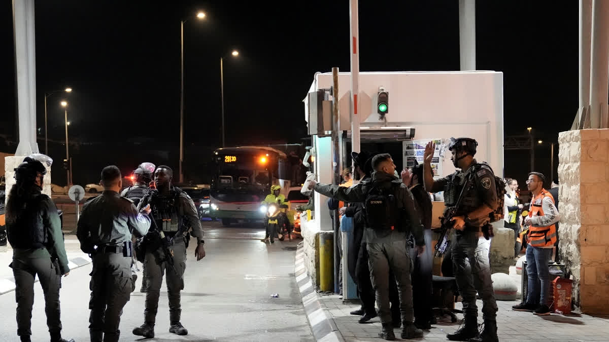 Israeli security forces work at the scene of a shooting attack on a bus near the West Bank town of Beit Jala, early Thursday, Dec. 12, 2024.