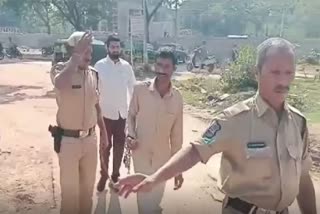 POLICE HANDCUFFING TO FARMER