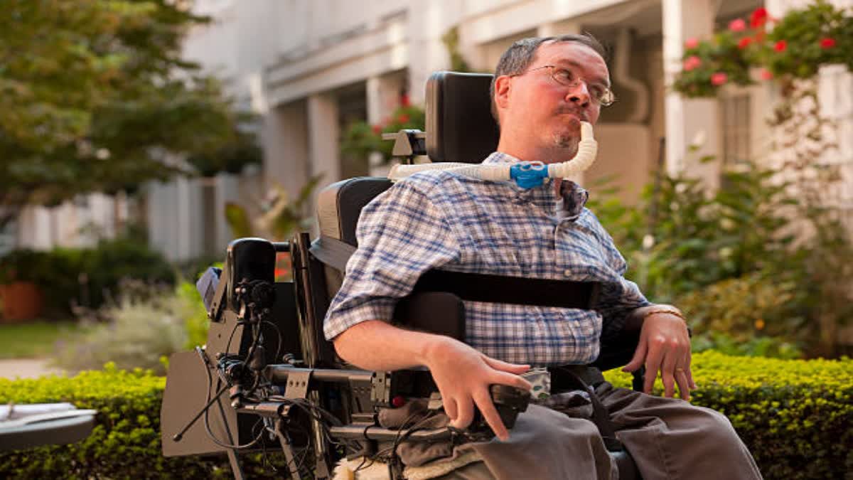 Man with Duchenne muscular dystrophy sitting in a wheelchair