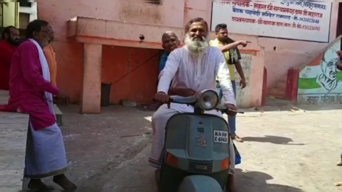 son taking mother on scooter to visit temples