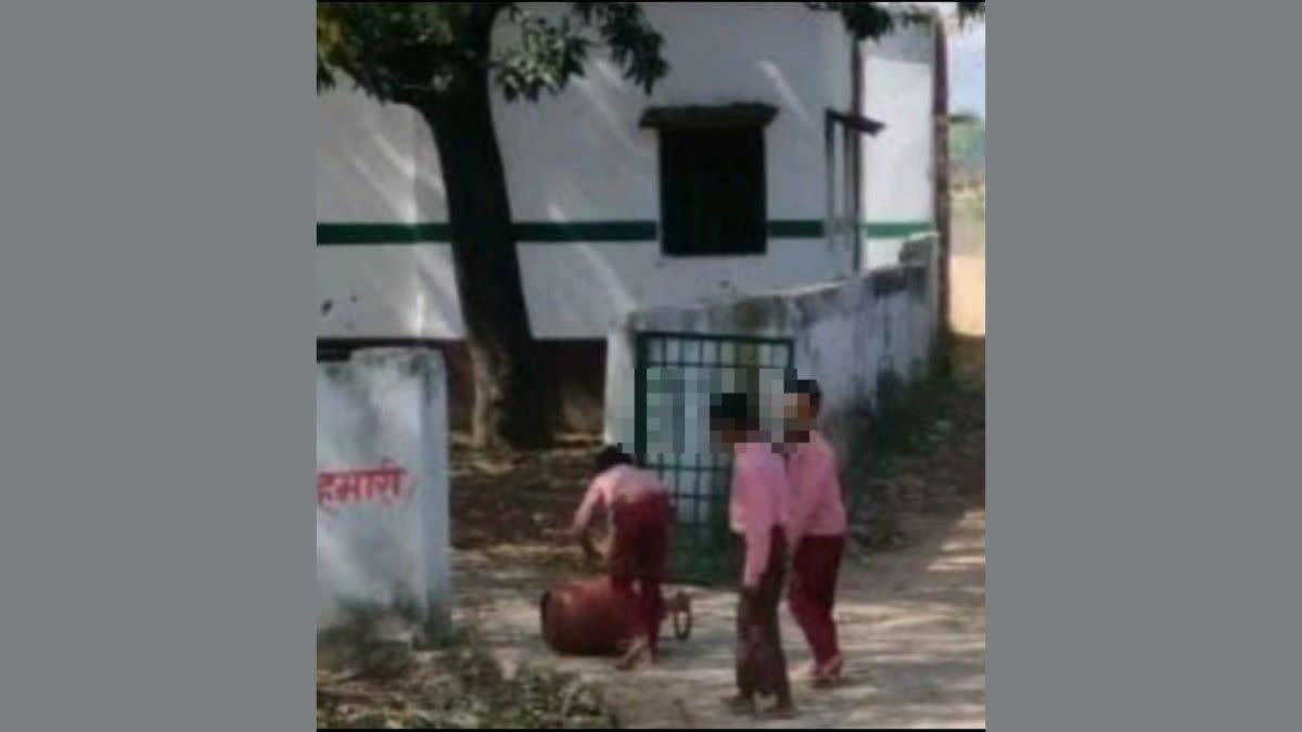 children carrying cylinder in School