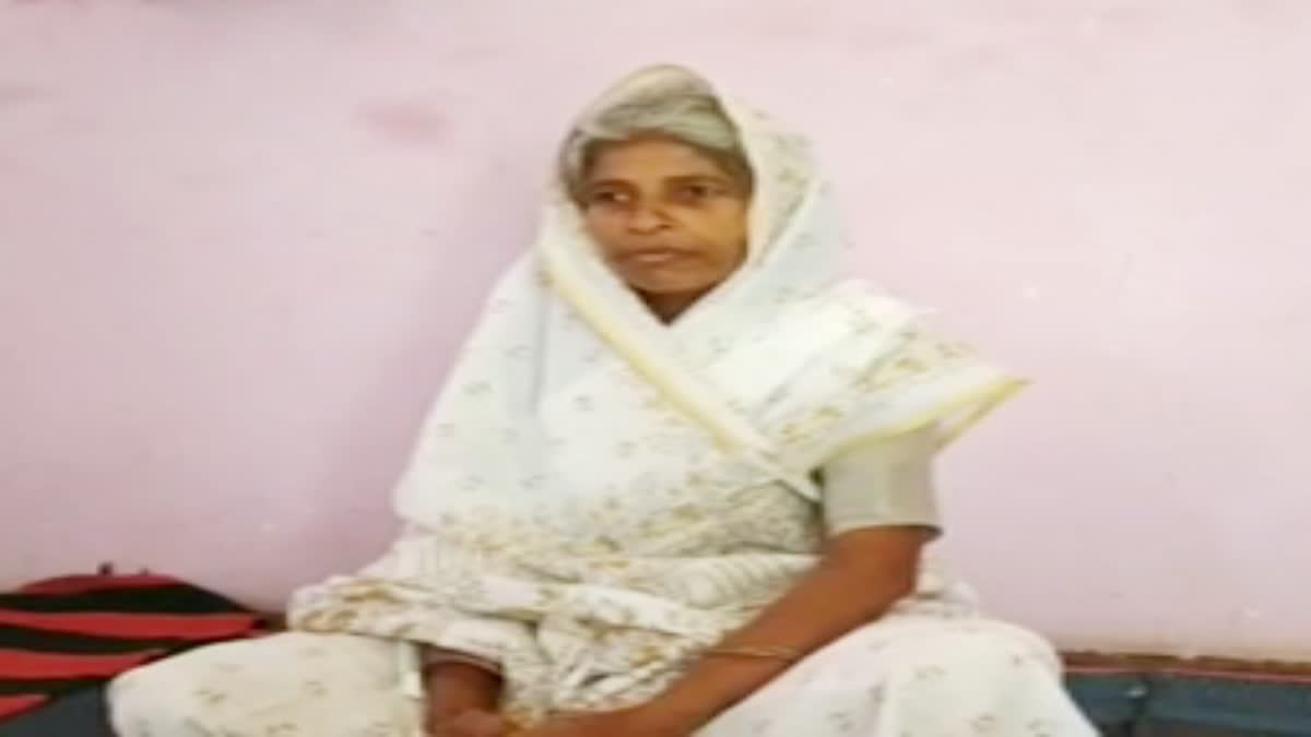 Elderly woman walking on banks of Narmada