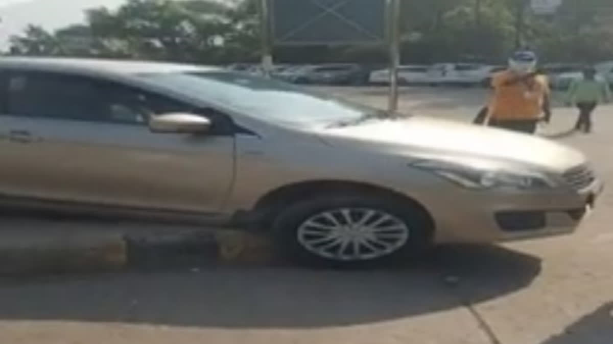 The car stuck on the pavement in Agra on Monday