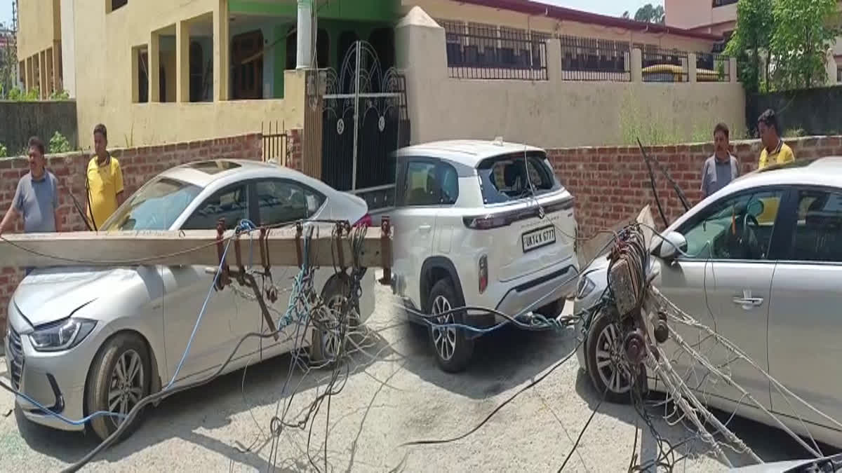 Two cars Damaged due to falling of Electric Poles