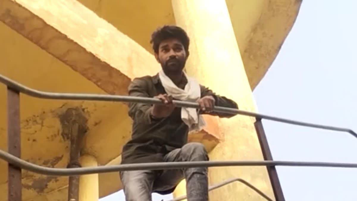 Angry young man climbed on water tank