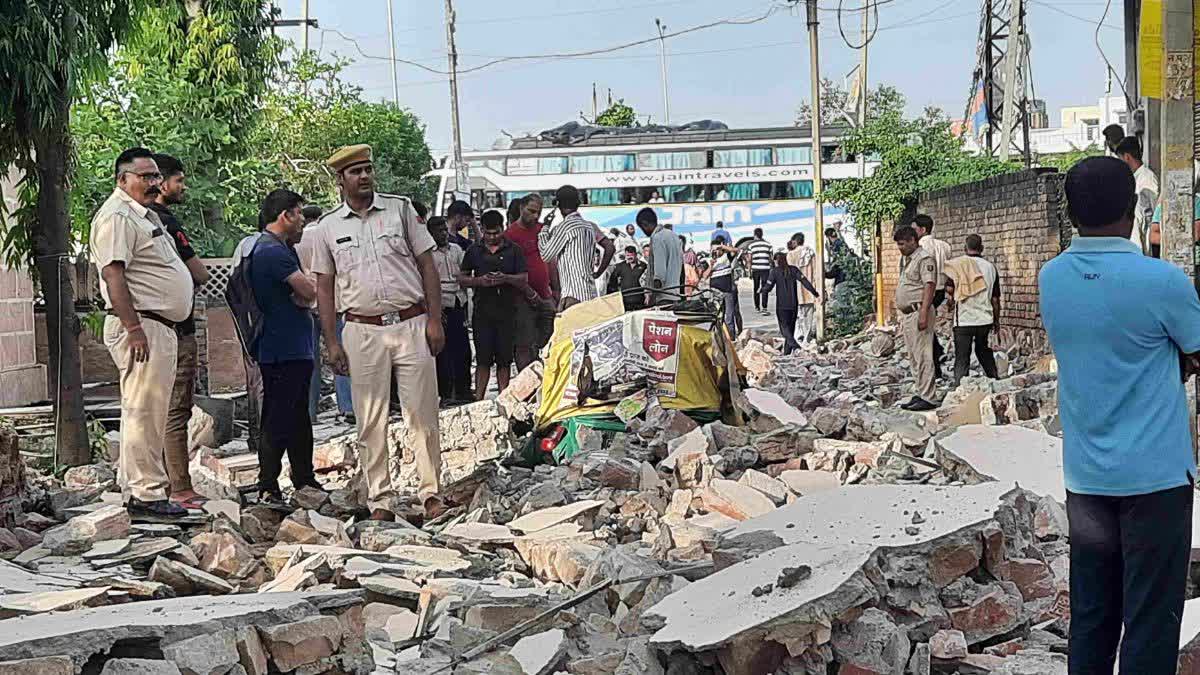 Hotel wall collapses on passing auto