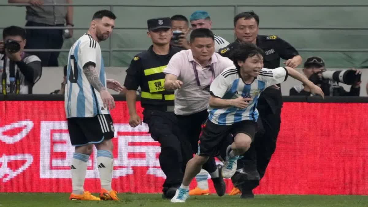 Lionel Messi scores, gets hugged by a fan during Argentina's 2-0 win over Australia