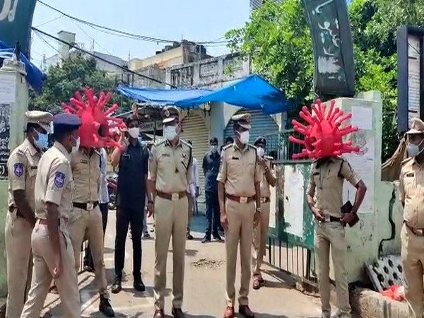 Personnel of the Hyderabad Police wear helmets shaped like COVID-19.